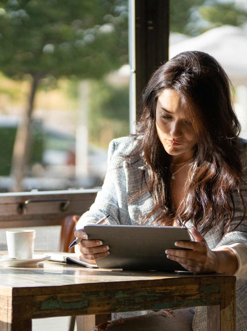 mobisurfer_woman_using_tablet_while_working_coffee_shop_2400px
